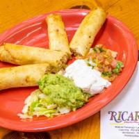 Flautas De Pollo · Chicken machaca with poblanos and cheese, rolled in flour tortillas, fried crisp and served ...