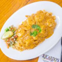 Camarones Chipotles · Shrimp cooked with butter, wine, garlic, chipotle chile and cream. Served over rice.