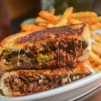 Dirty Pablo Grilled Cheese · Beef Chorizo, Smoked Poblano Peppers, Oaxaca Cheese, Red Chile Glaze served on a Toasted But...