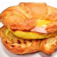 Croissant Breakfast Sandwich · Two scrambled eggs, ham, american cheese, sundried tomato pesto.