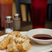 Fried Chicken Dumpling · 6 Pieces.  Includes sweet soy sauce.