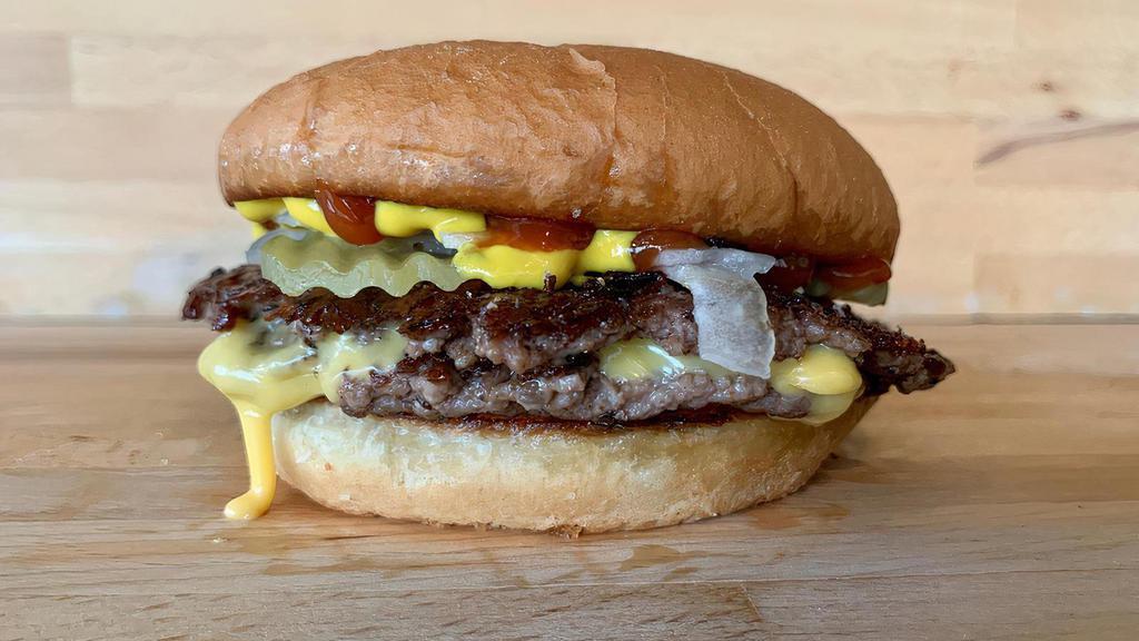 Double Snack · 2 2 Ounce Beef Patties, American Cheese, Pickle, Onion, Mustard, Ketchup