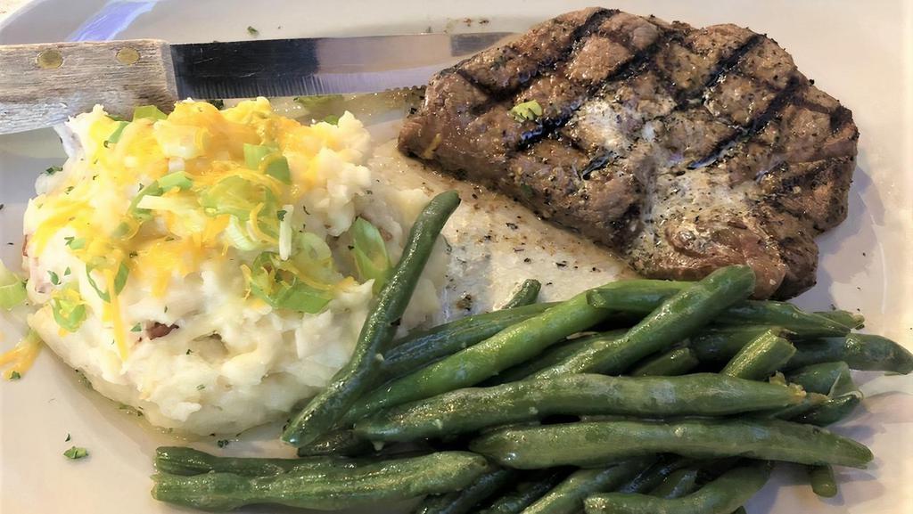 Wagyu Sirloin Steak* · Flame Grilled 8 oz. American Wagyu Top Sirloin Basted With Garlic Herb Butter.  With Loaded Mashed Potatoes + Sautéed Fresh Vegetables.