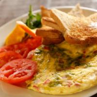 Italiano Omelette Breakfast · Roasted red peppers, garlic, feta and our amazing basil infusion. Made with three large farm...