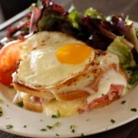Croque Madame Sandwich · With a sunny side egg on top. Thinly sliced ham, layered with bechamel, Gruyere and Parmesan...