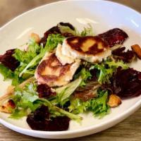 Roasted Beet & Warm Goat Cheese Salad · House roasted beets, warm crusted goat cheese and toasted walnuts on baby greens with our ch...