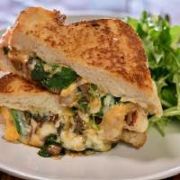 Grown-Up Grilled Cheese Sandwich · Triple cheese, balsamic grilled onions and spinach stuffed into our thick cut French box bre...