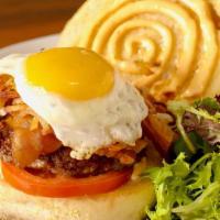 Le Breakfast Burger · Juicy burger with crispy hash browns, grilled local tomato, creamy cheddar cheese, crisp bac...