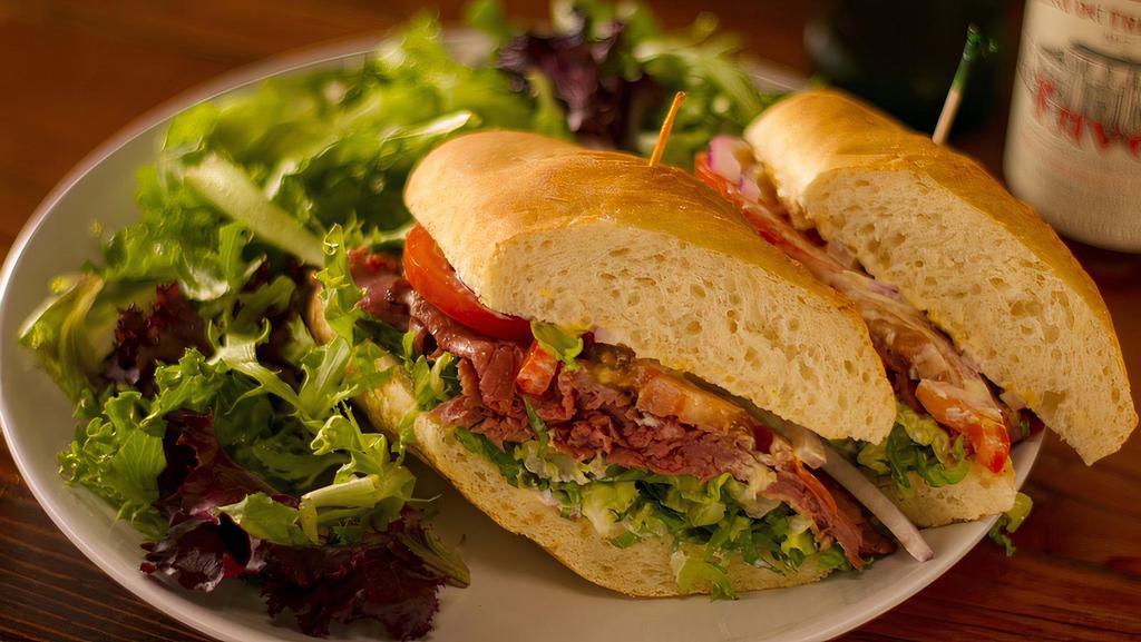 Le Boeuf Sandwich (Roast Beef) · Oven-roasted prime beef, local tomato, leaf lettuce, onion, extra spicy dijon, mayo and creamy horseradish on a French baguette.