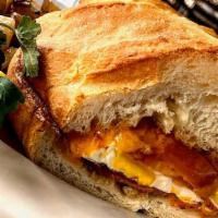 Grilled Breakfast Sandwich · Two farm eggs cooked over well with grilled tomatoes and cheddar cheese on fresh buttered Fr...