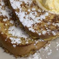 French Toast · Thick Texas toast dipped in vanilla custard batter, grilled and sprinkled with powdered suga...