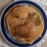 Blueberry Pancakes · Two blueberry pancakes served with butter and warm syrup.