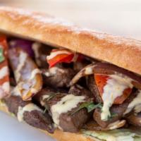 Lomo Saltado Sandwich · Steak and onions sautéed in a fiery wok and marinated in a soy and oyster sauce, lettuce, to...