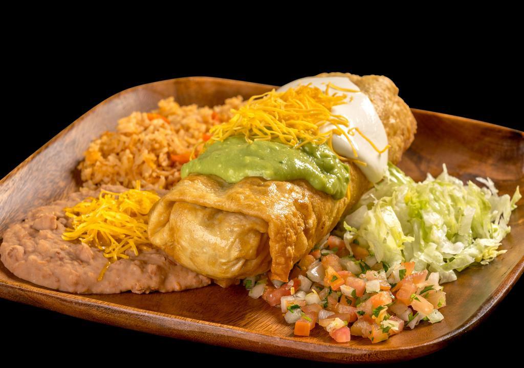 #13. Chimichanga Plate · Shredded beef or chicken burrito, deep fried, topped with guacamole, sour cream, cheese, pico de gallo and lettuce.