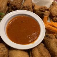 Crispy Chicken Wings · Battered fried chicken wings served naked! Celery, carrots, ranch dressing and our own hot s...