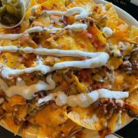 Nachos · Fresh tortilla chips topped with our own zesty Arizona chili, smothered in melted monterey j...