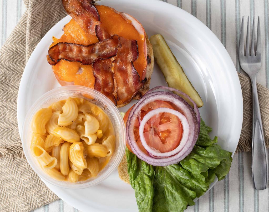 Chicken Club Sandwich · Fried or grilled chicken breast, sliced ham, cheddar cheese, bacon, lettuce, tomato & onions. Served on a toasted bun.