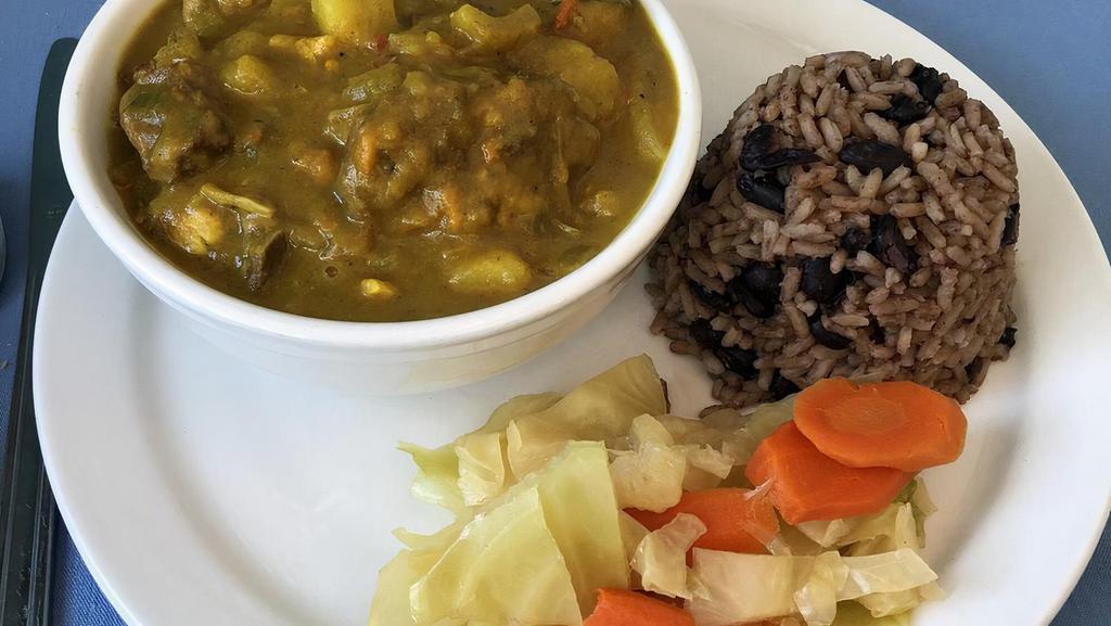 Curry Goat · Served with rice and vegetables.
