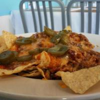 Bbq Nachos · With chili, chips, jalapeños and cheese.