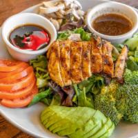 Teriyaki Chicken Salad · Teriyaki chicken breast with green spring mix, carrots, and avocados served with a ginger dr...