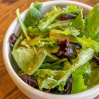 House Salad · Green spring mix served with a homemade ginger dressing.
