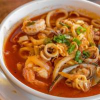 Spicy Seafood Udon Soup · Japanese thick wheat noodles with vegetables & seafood in a spicy broth.