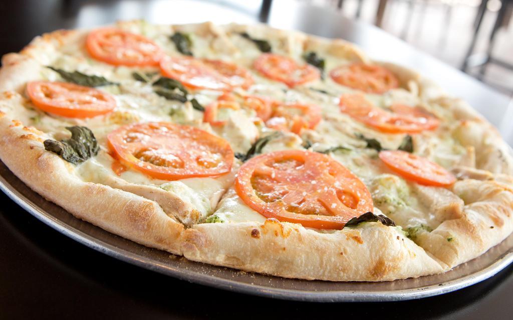 Chicken Bruschetta · Pesto based pizza topped with mozzarella, ricotta, grilled chicken, tomatoes and basil.