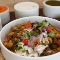 Aloo Tikki Chaat · Street style stir-fried chickpeas, onions, tomatoes and cilantro served a top house-made spi...