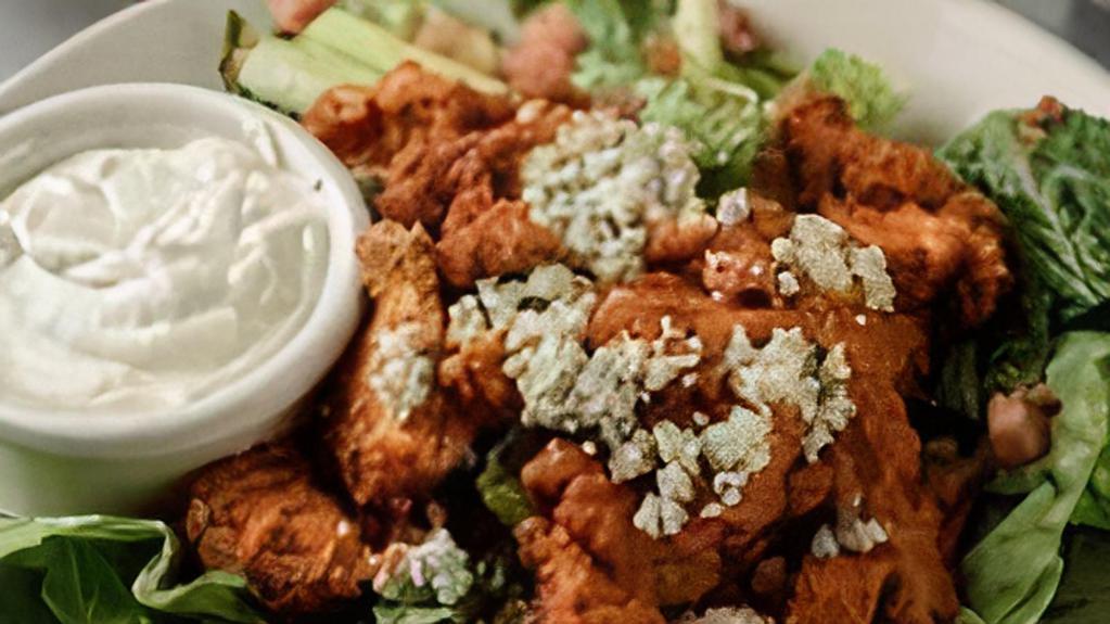 Buffalo Chicken Salad · Fresh romaine lettuce tossed with blue cheese crumbles, bacon, diced tomatoes, topped with a fried chicken breast dipped in our buffalo wing sauce.