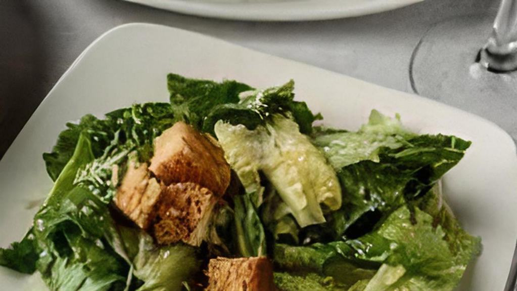 Caesar Salad · Romaine lettuce in Caesar dressing topped with croutons and Parmesan cheese.