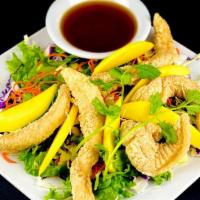 Pla Mango Salad · Crispy fish, ripe mango and fresh garden greens, tossed in a pickled garlic lemon dressing. ...