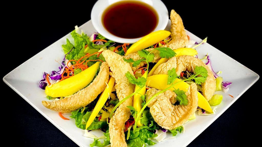 Pla Mango Salad · Crispy fish, ripe mango and fresh garden greens, tossed in a pickled garlic lemon dressing. Can be made GF (fish will be steamed). Please make notation in notes.
