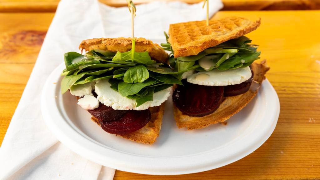Beet Napoleon · Roasted beets, chevre cheese, fresh spinach splashed with champagne vinaigrette and maple butter.