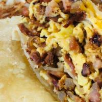 Breakfast Burrito · Scrambled eggs, sautéed onions, ham and bacon with melted cheese. It's
wrapped in a warm flo...