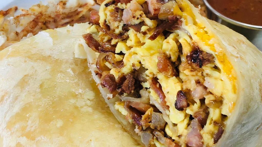 Breakfast Burrito · Scrambled eggs, sautéed onions, ham and bacon with melted cheese. It's
wrapped in a warm flour tortilla, with a side O'Brien hash brown and salsa.