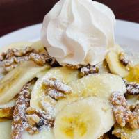 Banana Walnut Pancakes · 3 buttermilk pancakes with fresh sliced bananas, crunchy walnuts, drizzled with sweet conden...