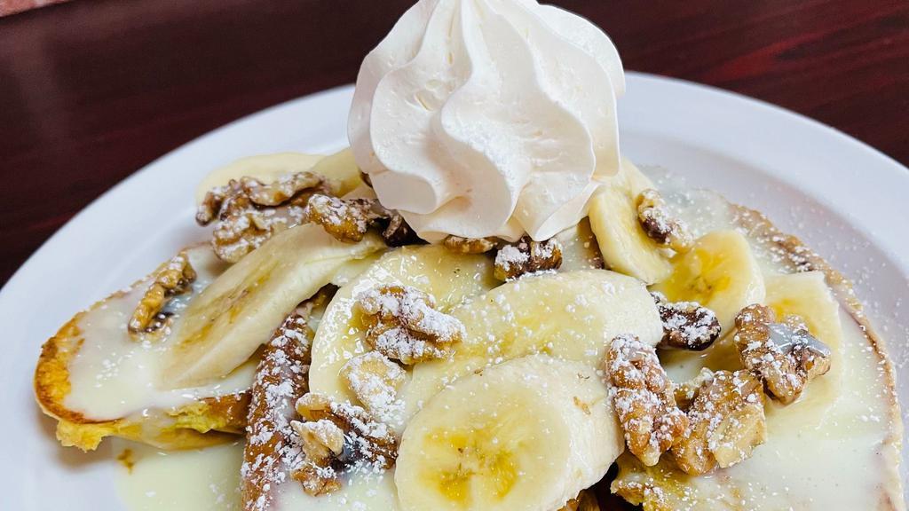 Banana Walnut Pancakes · 3 buttermilk pancakes with fresh sliced bananas, crunchy walnuts, drizzled with sweet condensed milk, topped with powdered sugar and whipped cream.