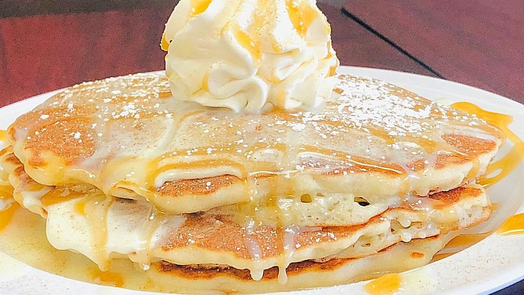 Churro Heaven Pancakes · 3 fluffy Buttermilk Pancakes. Layered with delicious sweet cream. Topped with cinnamon-sugar sprinkle, caramel drizzle, condensed milk, whipped cream and powdered sugar.