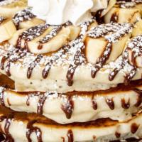 Banana Nutella Pancakes · 3 fluffy Buttermilk Pancakes. Topped with fresh sliced bananas. Rich Nutella drizzle, whippe...