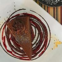 Chocolate Cheesecake · (vegan, gluten-free). Chocolate-cinnamon cheesecake drizzled with chocolate sauce.