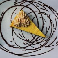 Passion Fruit Cheesecake · (vegan, gluten-free). Passionfruit cheesecake drizzled with chocolate sauce.
