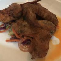 Chicken Wings · Crispy skin, chile oil, carrot, cabbage, red onion, celery, roquefort slaw.