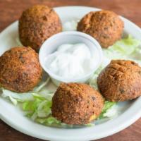 Falafel (5 Pcs) (V) · Chickpea and fava beans ground with vegetables and spices. Served with tahini sauce, tomatoe...