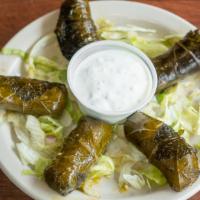 Grape Leaves (5 Pcs) (V) · Rolled grape leaves stuffed with rice, onions, tomatoes and parsley. Cooked in seasoned lemo...