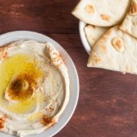 Regular Hummus · Garbanzo beans, garlic, tahini sauce topped with olive oil served with pita bread.