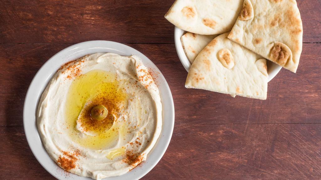 Large Hummus · Garbanzo beans, garlic, tahini sauce topped with olive oil served with pita bread.