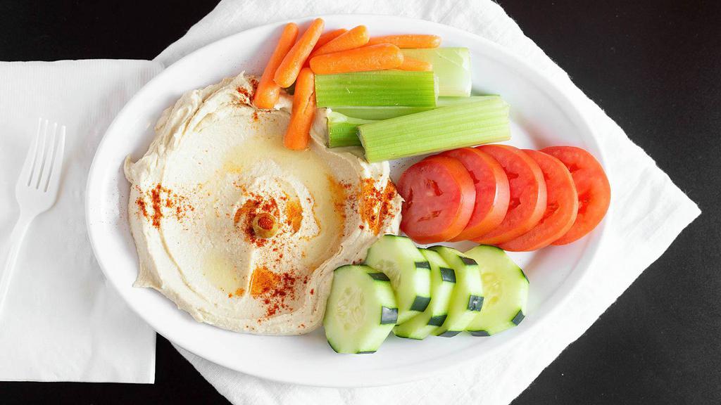 Hummus With Raw Vegetables · Garbanzo beans, garlic, tahini sauce topped with olive oil served with pita bread and raw vegetables. Vegetarian.