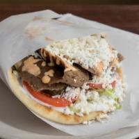 Blazin' Lamb Gyro · Rotisserie cooked lamb/beef gyro strips served in a pita bread with tomatoes, pickles, lettu...