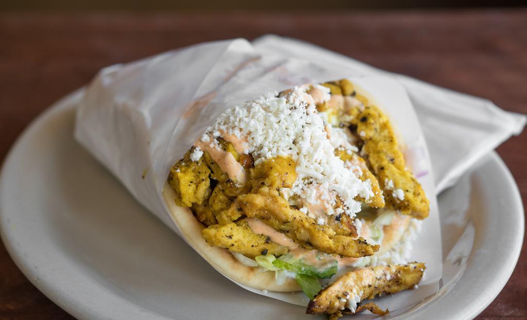 Blazin' Chicken Gyro · Grilled chicken gyro strips, served in a pita bread with pickles, tomatoes, lettuce and onions topped with tzatziki sauce, our signature Blazin' Sauce and feta cheese.
