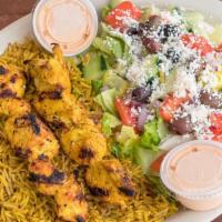 Chicken Kebab Platter · 2 fire grilled skewers of seasoned chicken kebab served on a bed of rice along with Greek sa...